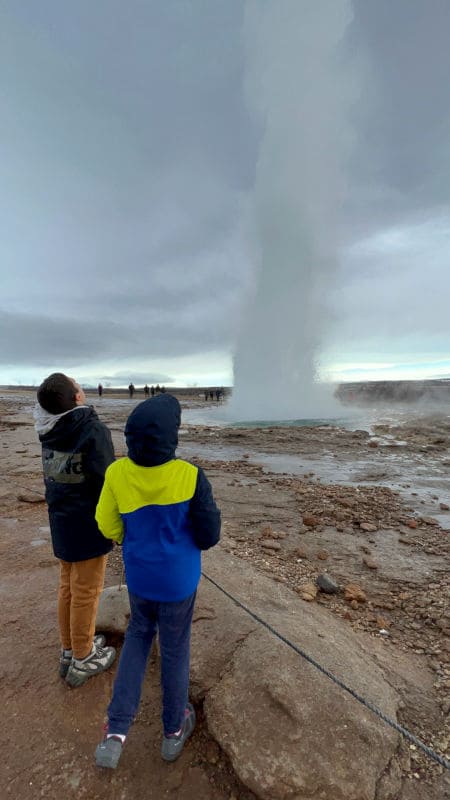 Teo y Oriol viendo un geiser en Islandia